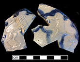 Gray-bodied salt glazed stoneware  jug  with applied lions outlined with cobalt-blue under the glaze.  Both sherds appear to be from the same vessel. Lot number: 18CV60-1.428.